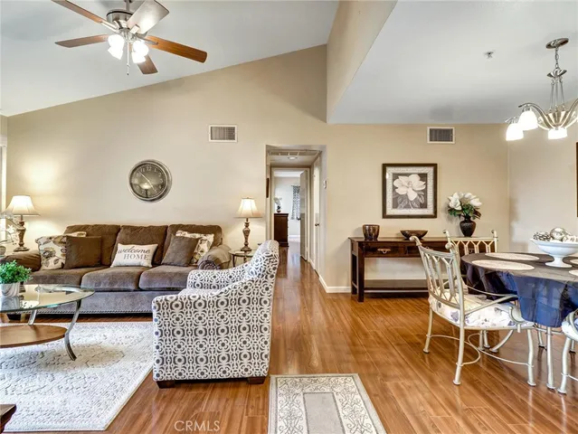 a living room with furniture and wooden floor
