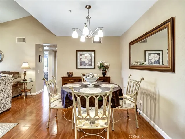 a view of a dining room with furniture wooden floor and chandelier