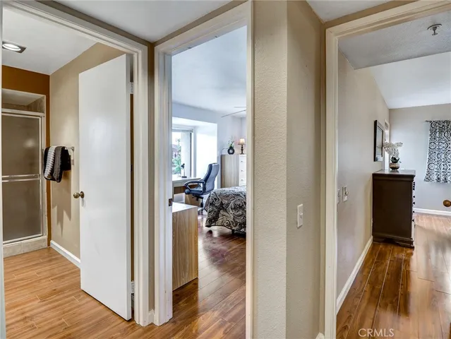 a view of a hallway view with wooden floor and living room