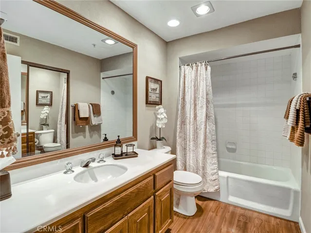 a bathroom with a sink a toilet and a large mirror