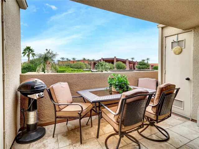 a view of a house with a yard and potted plants