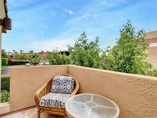 a view of swimming pool with outdoor seating and a garden