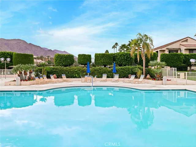a front view of a house with a garden and yard