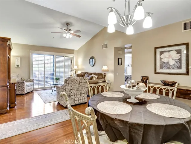 a view of a dining room with furniture wooden floor and chandelier