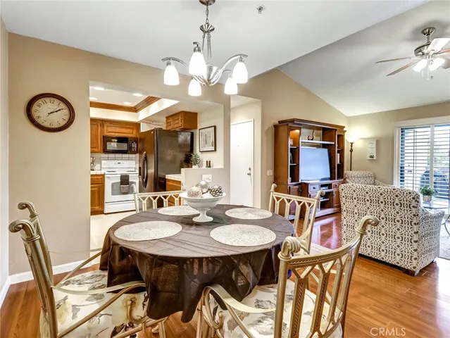 a view of a dining room with furniture and a chandelier