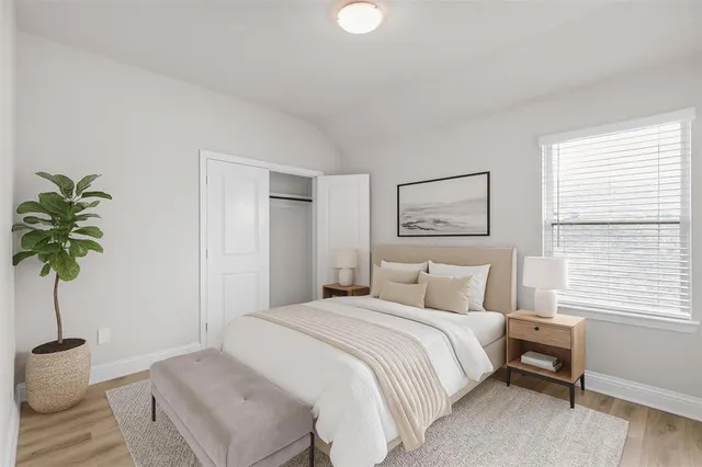 a bedroom with a bed and a potted plant