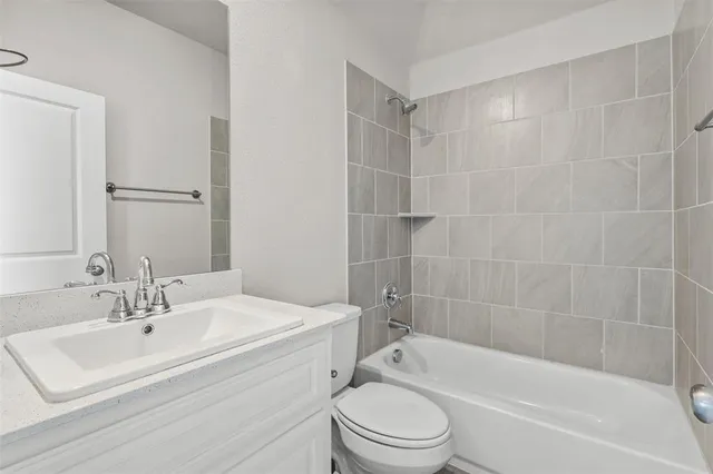 a bathroom with a sink toilet and bathtub