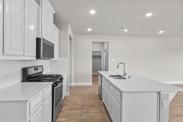 a kitchen that has a sink and a stove