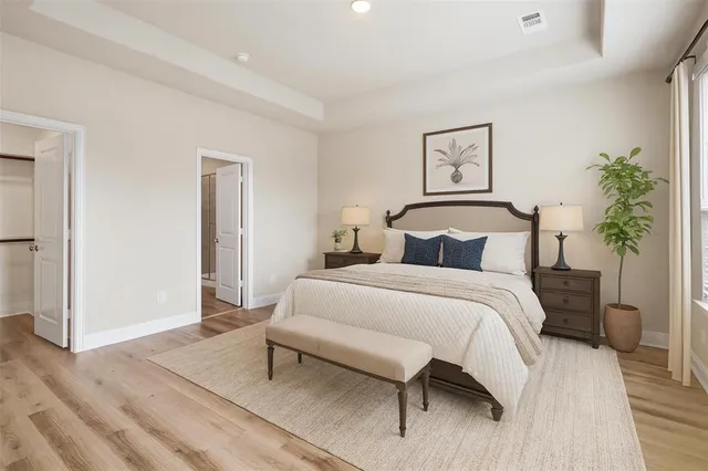 a bedroom with a bed and a potted plant