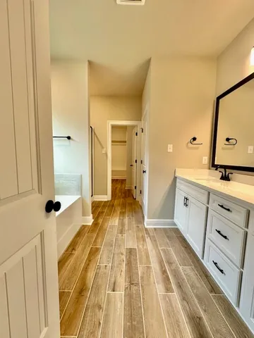 a spacious bathroom with a sink and a mirror