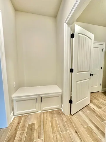 a view of a room with wooden floor and white walls