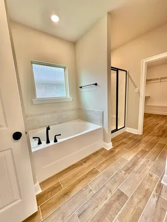a bathroom with a bathtub and shower