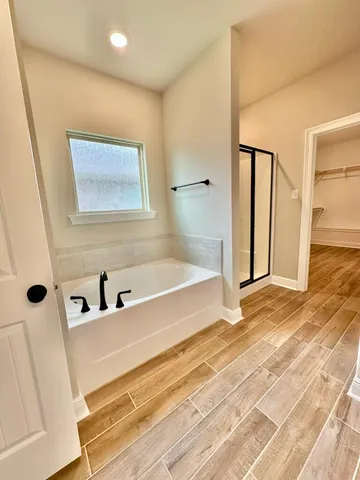 a bathroom with a bathtub and shower