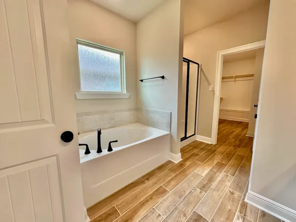 a bathroom with a tub and shower