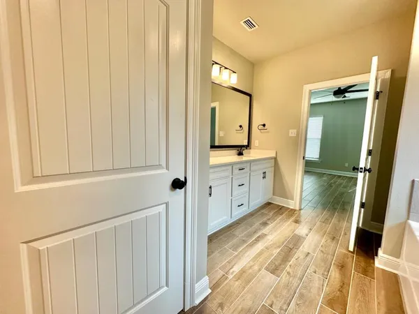 a spacious bathroom with a sink a mirror and a shower