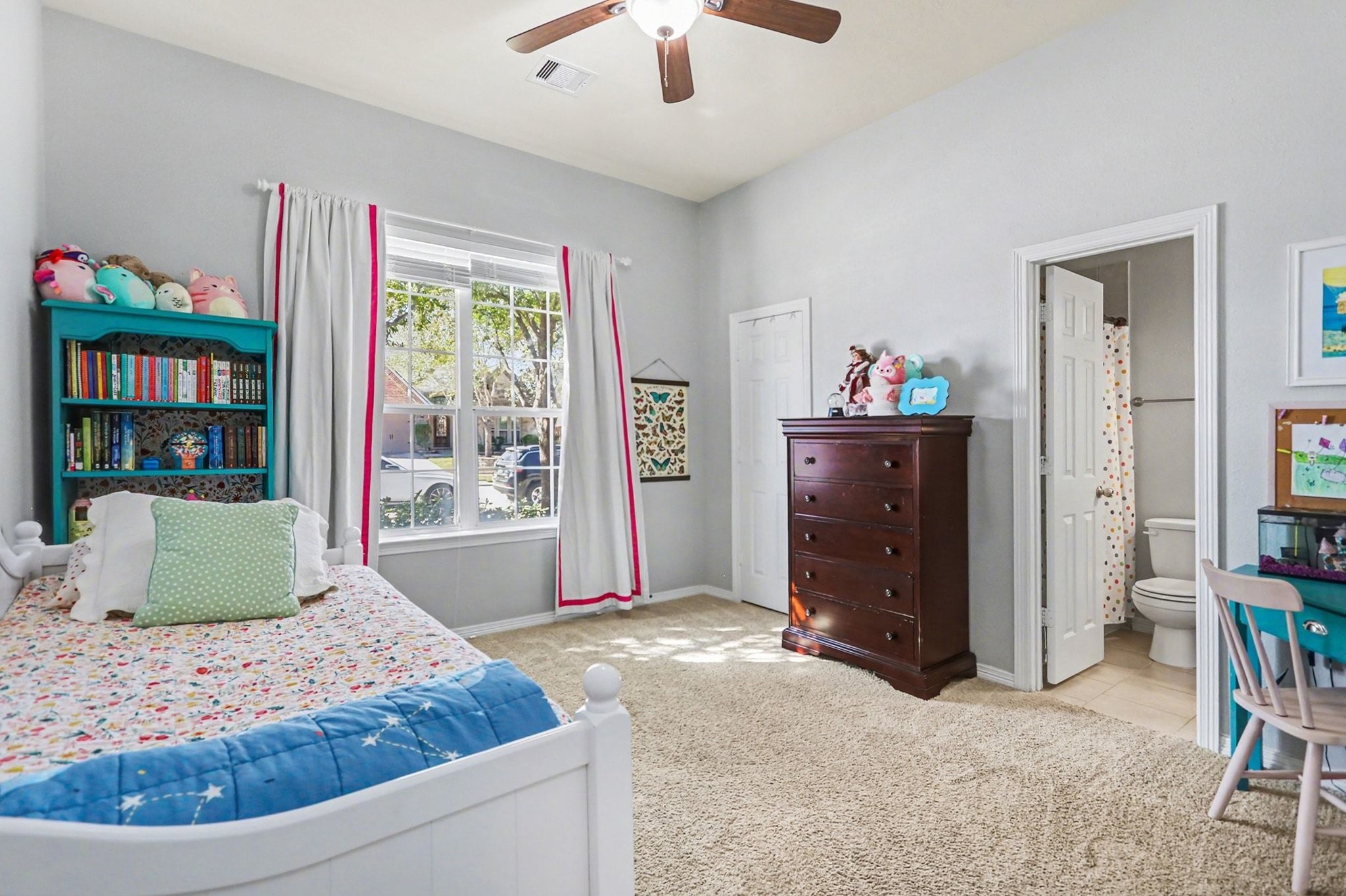 27006 Cliff Pointe Lane Katy, TX 77494 - Photo 24 of 34 Bright and cheerful secondary bedroom with plush carpet, ceiling fan, and plenty of space for a bed, desk, or play area.