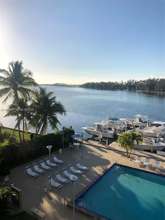 a view of a house with pool and a yard