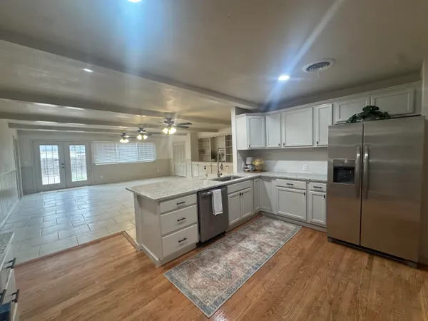 a bathroom with a granite countertop sink a toilet and a mirror