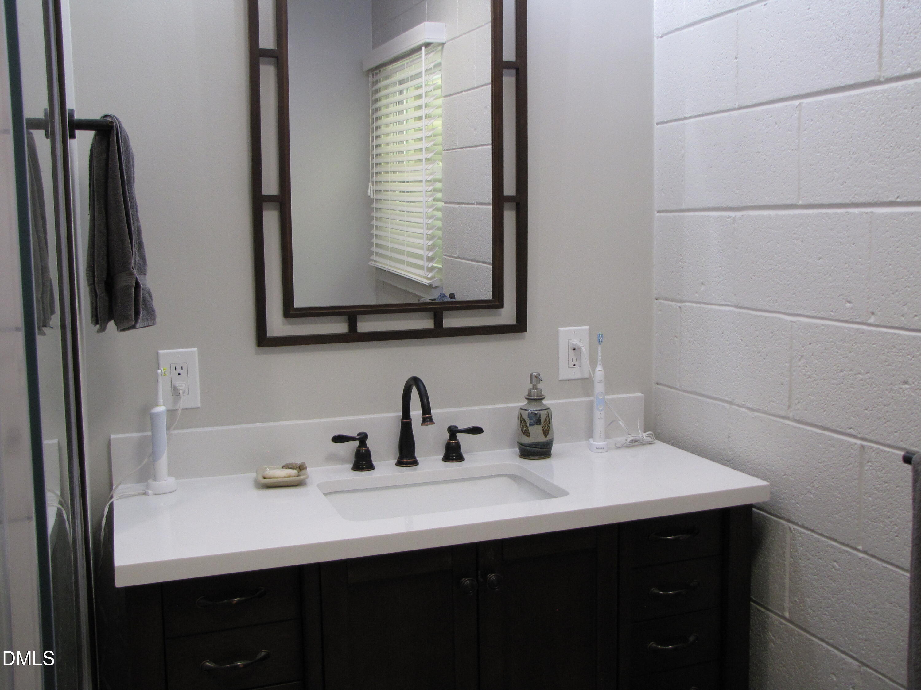 2907 Elgin Street Durham, NC 27704 - Photo 13 of 19 a bathroom with a sink and a mirror