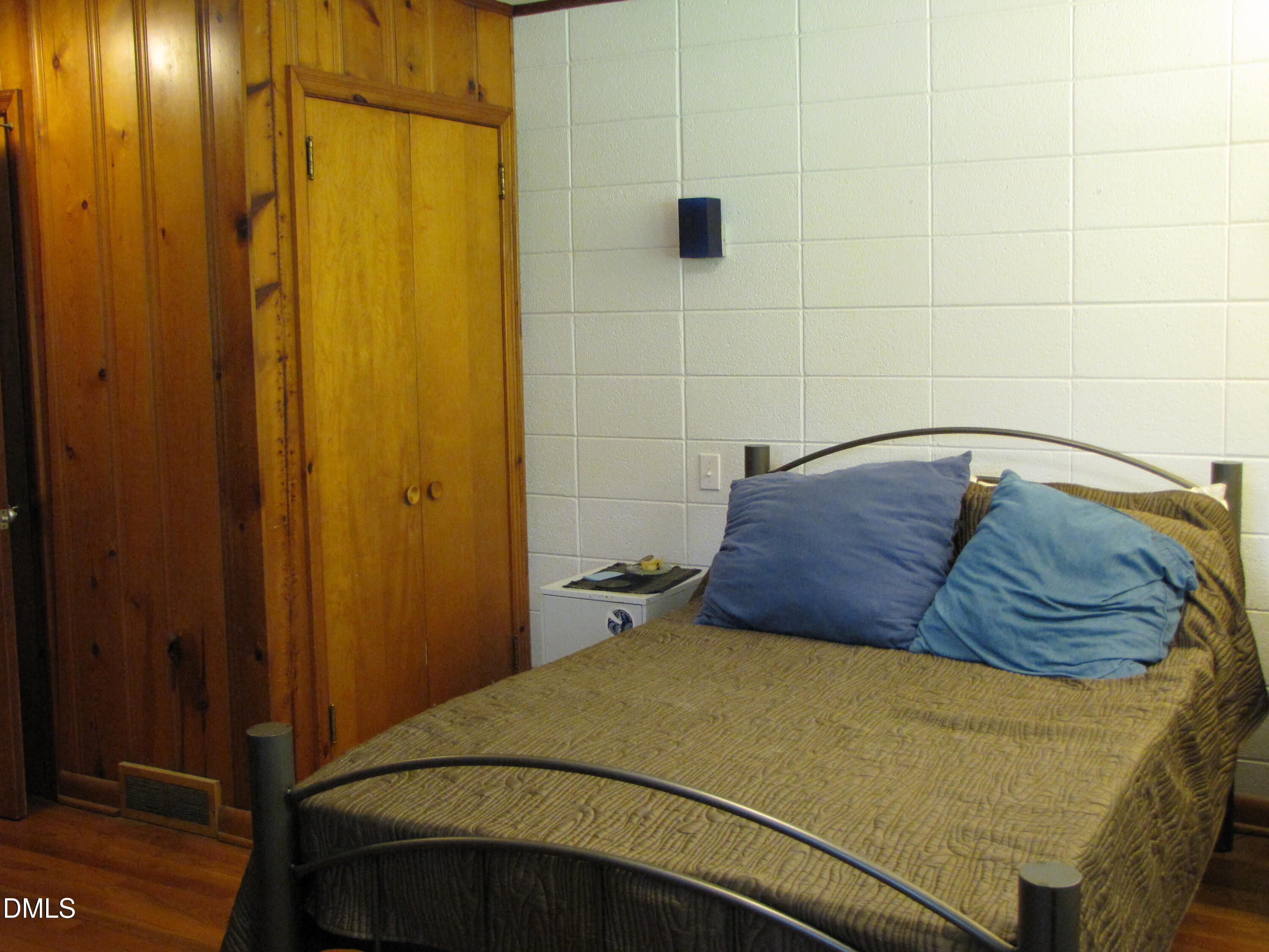 2907 Elgin Street Durham, NC 27704 - Photo 15 of 19 a bedroom with a bed and wooden floor