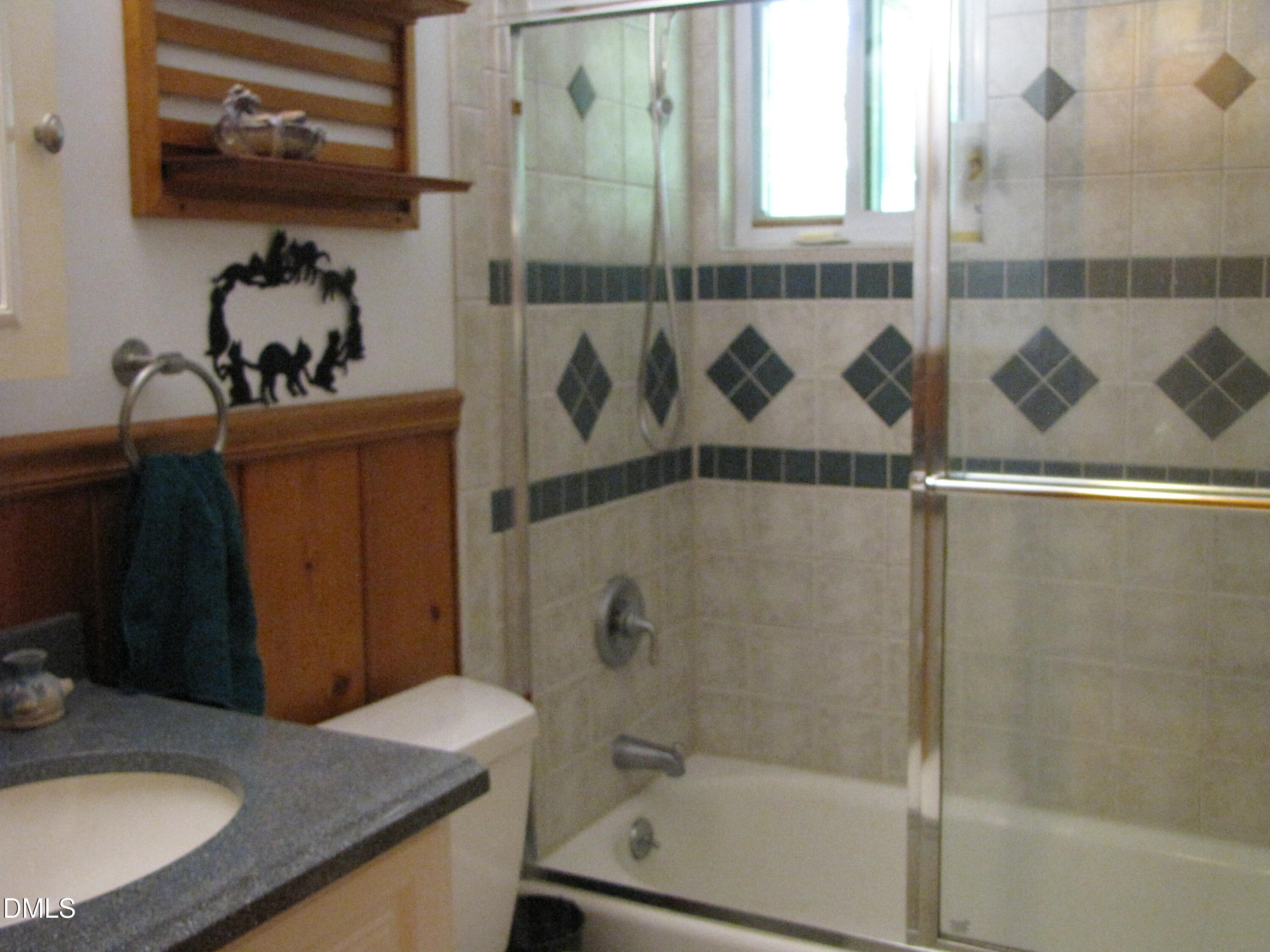 2907 Elgin Street Durham, NC 27704 - Photo 17 of 19 a bathroom with a granite countertop sink a mirror and shower