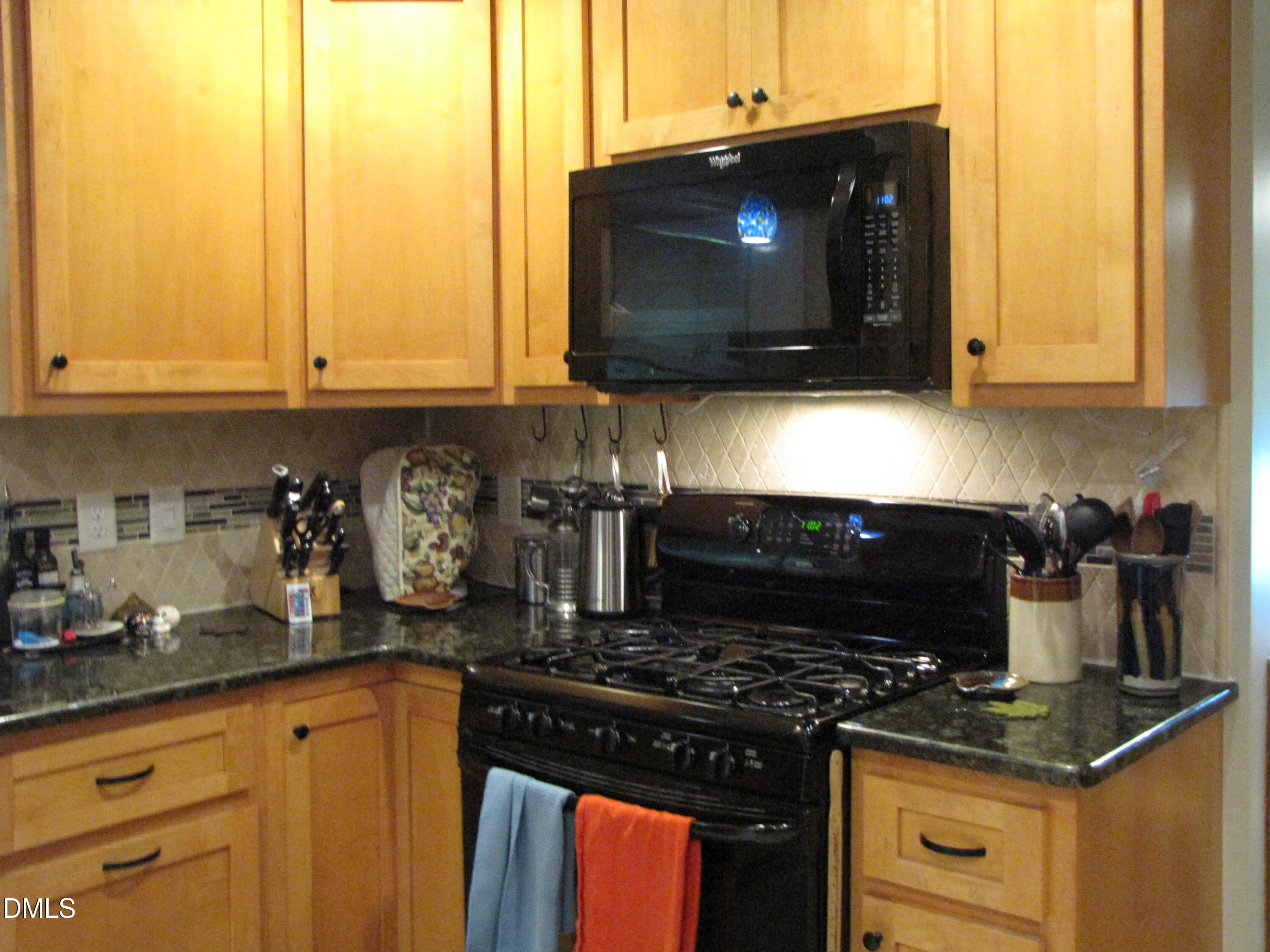 2907 Elgin Street Durham, NC 27704 - Photo 6 of 19 a kitchen with stainless steel appliances granite countertop a stove and a microwave