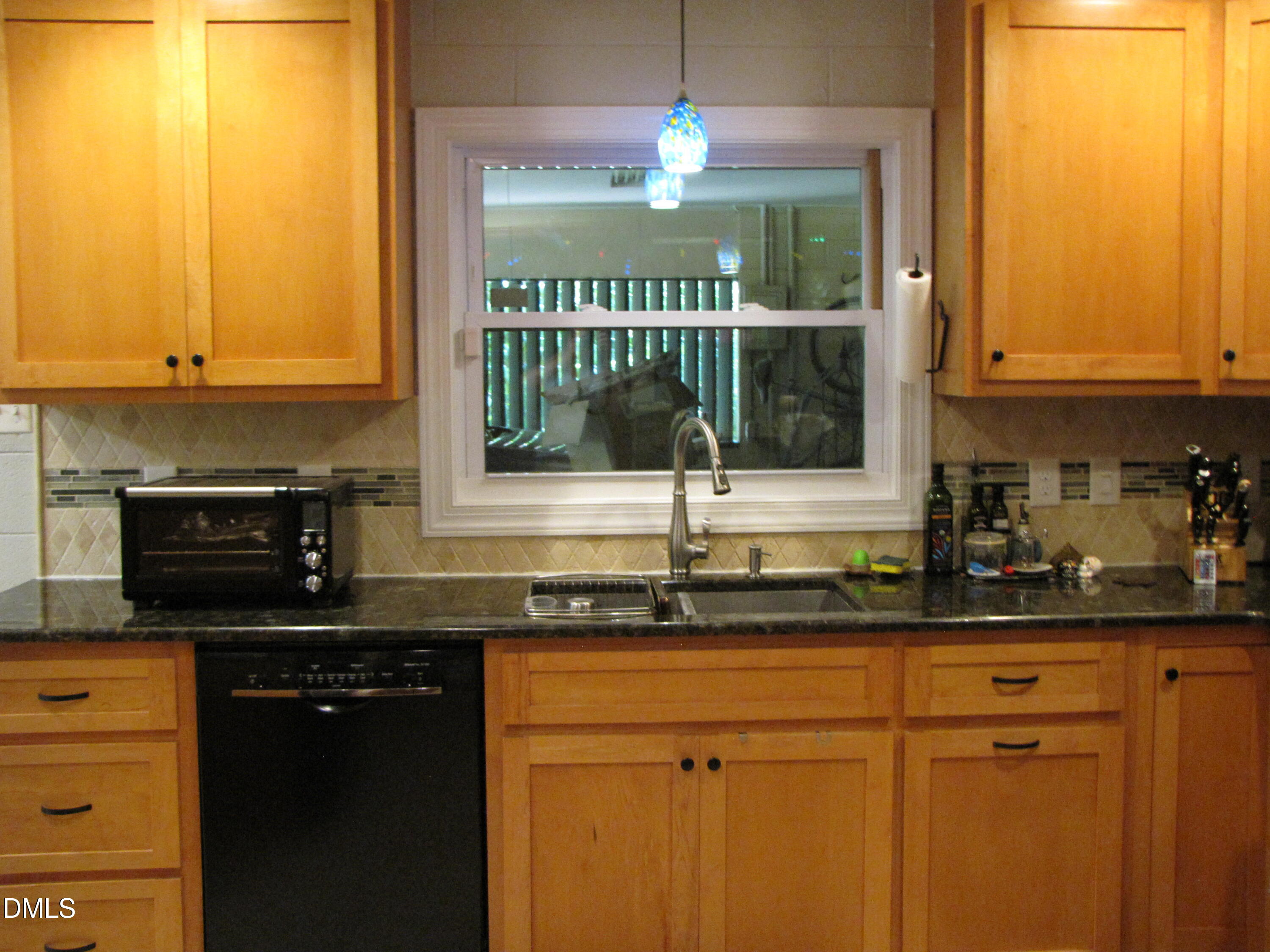 2907 Elgin Street Durham, NC 27704 - Photo 9 of 19 a kitchen with stainless steel appliances granite countertop a sink and a microwave
