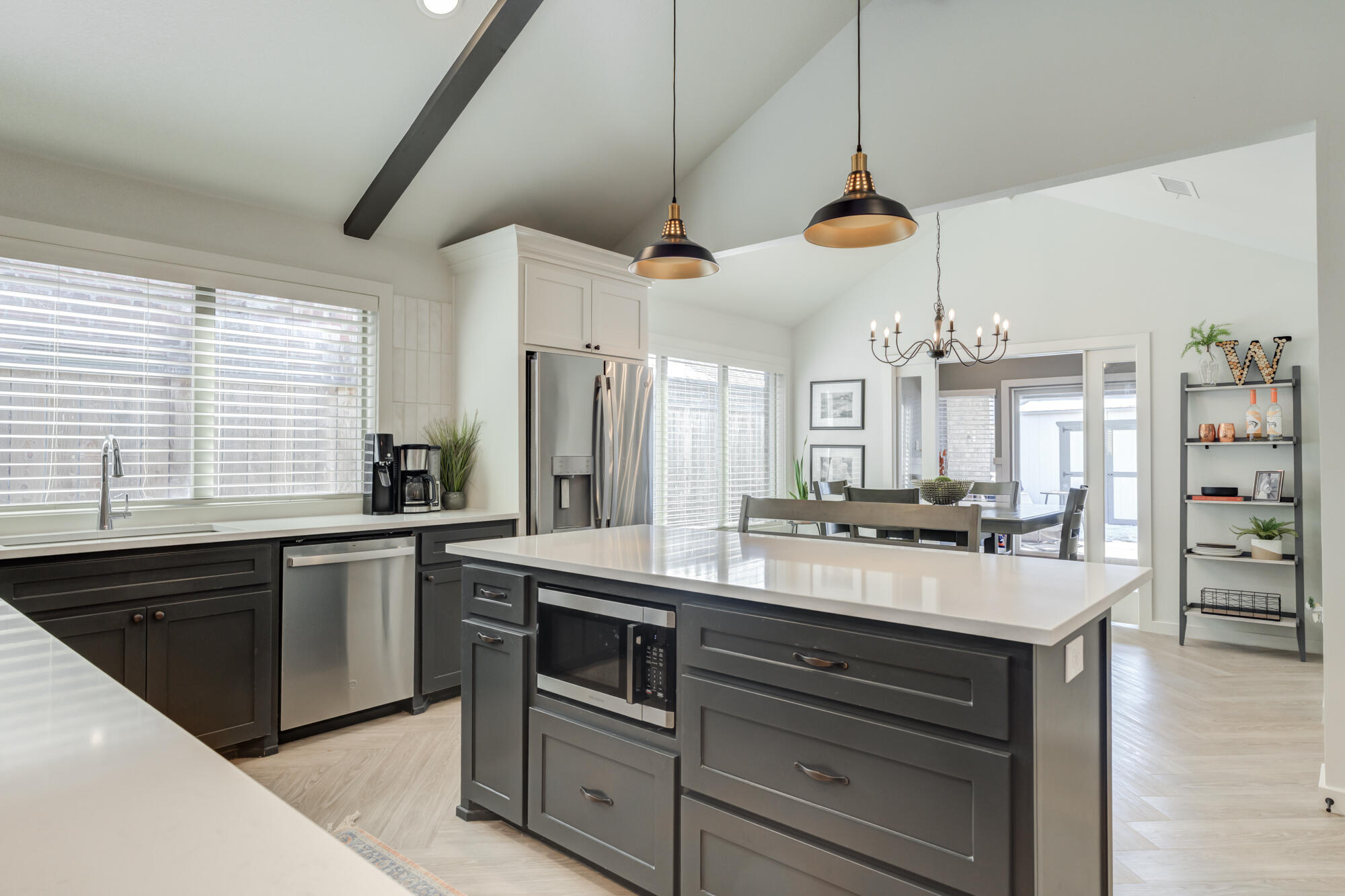 3627 128th Street Lubbock, TX 79423 - Photo 16 of 60 a kitchen with kitchen island granite countertop a sink a counter space appliances and cabinets