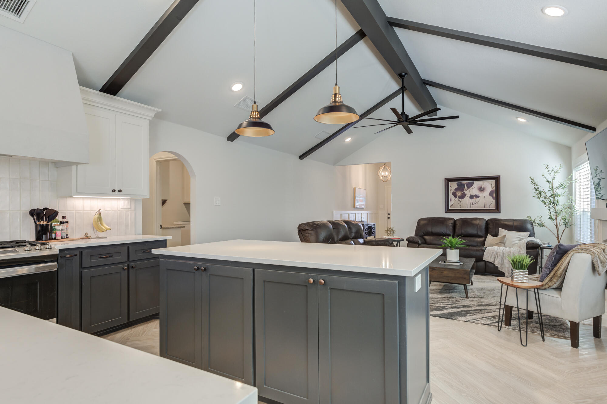 3627 128th Street Lubbock, TX 79423 - Photo 24 of 60 a kitchen with a sink a stove cabinets and wooden floor