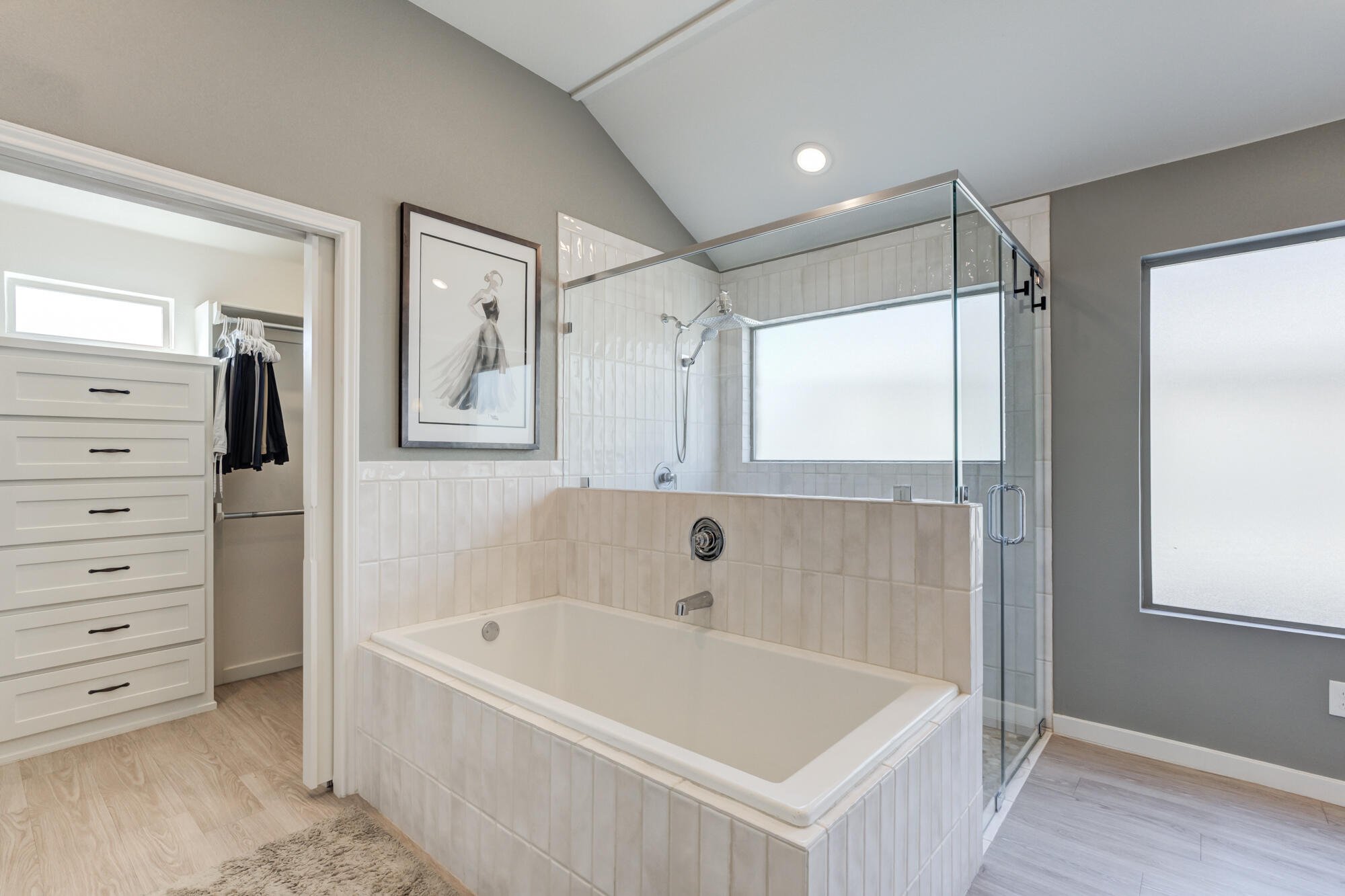 3627 128th Street Lubbock, TX 79423 - Photo 33 of 60 a bathroom with a bathtub a mirror a vanity and a shower