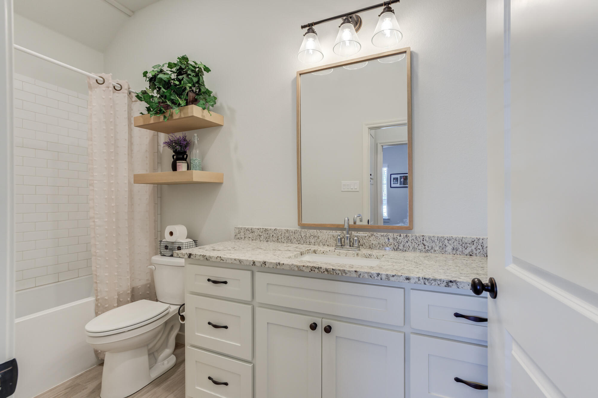 3627 128th Street Lubbock, TX 79423 - Photo 45 of 60 a bathroom with a sink toilet and shower