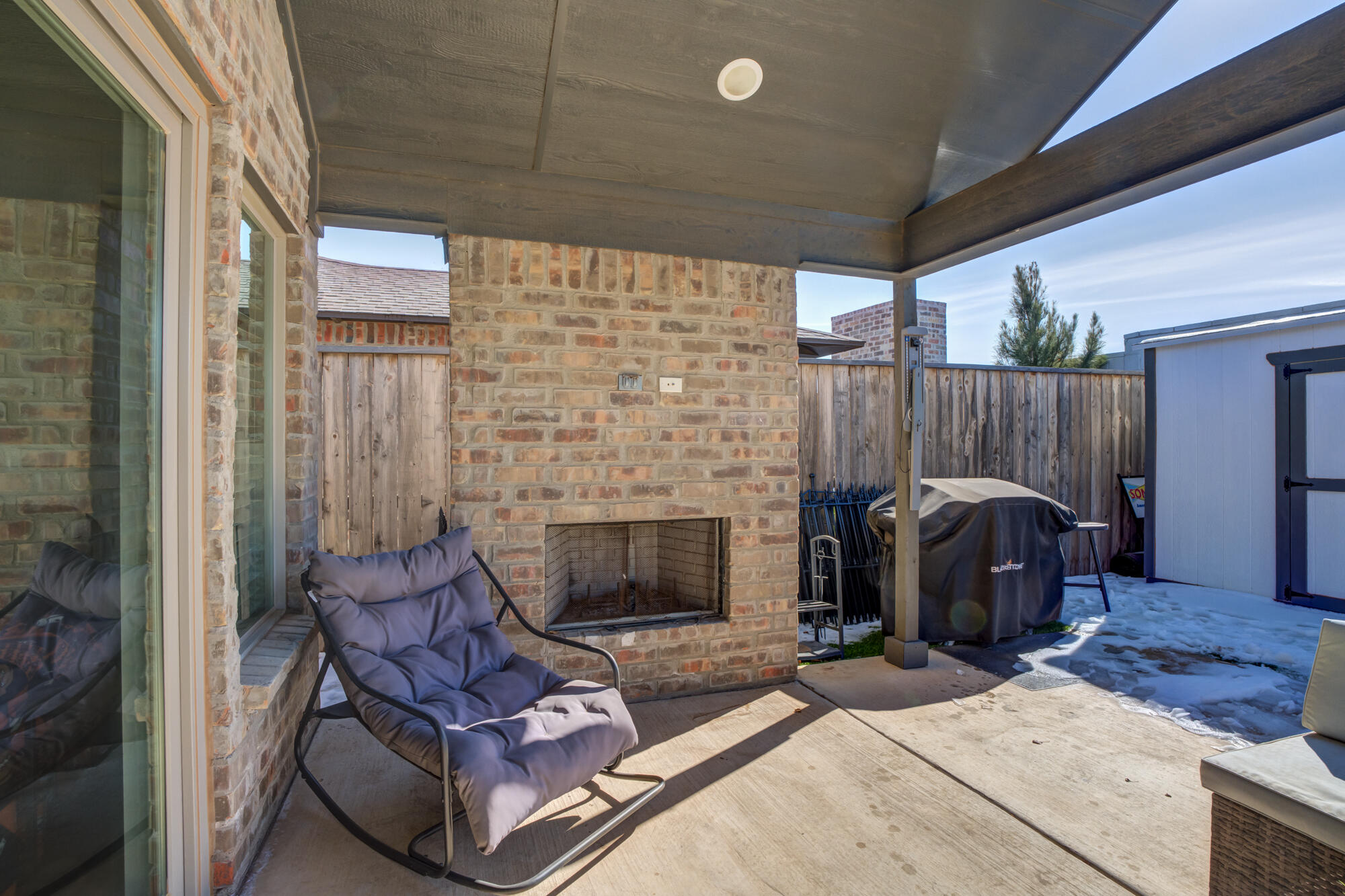 3627 128th Street Lubbock, TX 79423 - Photo 55 of 60 a living room with furniture a fireplace and a flat screen tv
