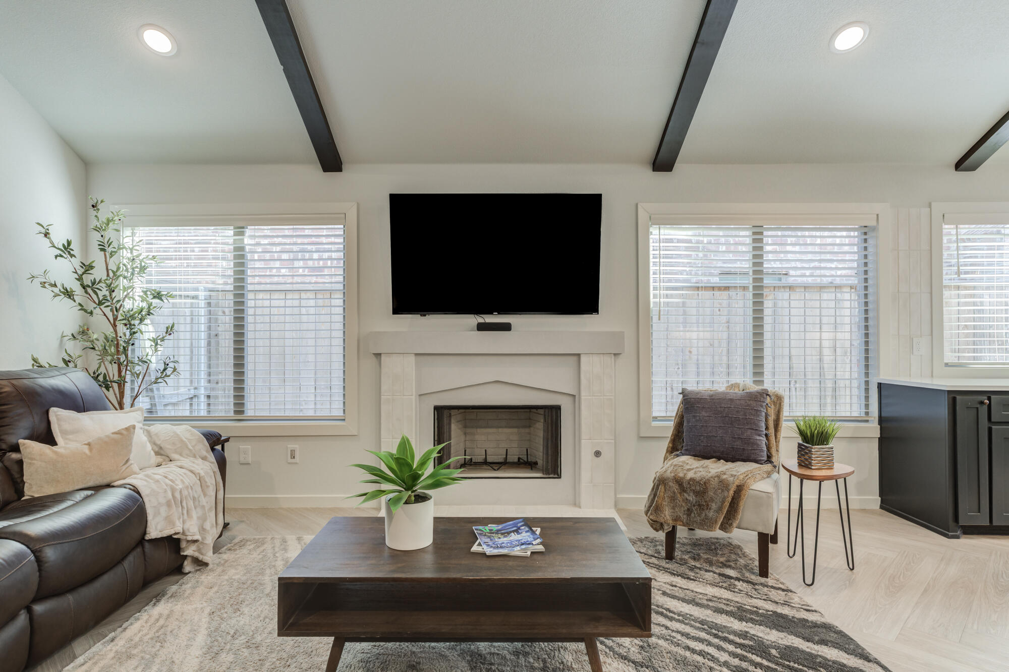 3627 128th Street Lubbock, TX 79423 - Photo 7 of 60 a living room with furniture a fireplace and a flat screen tv