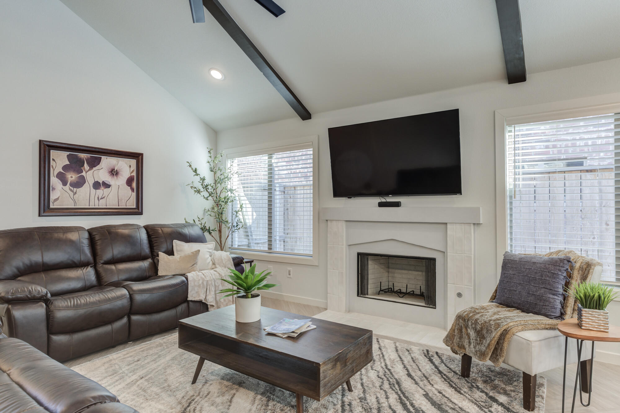3627 128th Street Lubbock, TX 79423 - Photo 8 of 60 a living room with furniture a fireplace and a flat screen tv