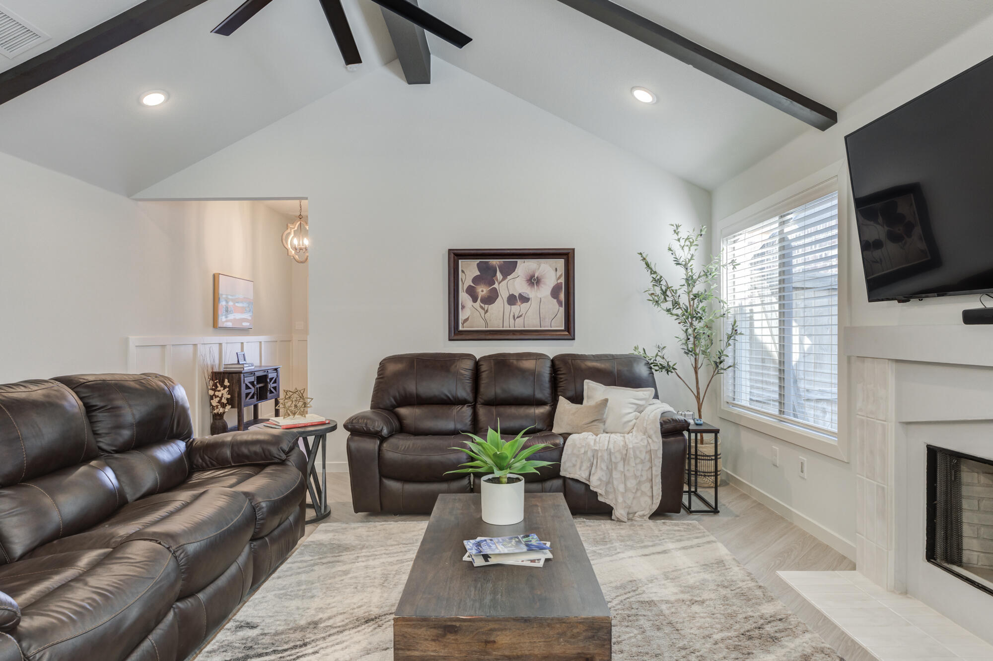 3627 128th Street Lubbock, TX 79423 - Photo 9 of 60 a living room with furniture a flat screen tv and a fireplace