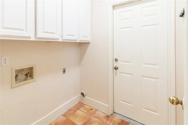 a view of a kitchen with white cabinets