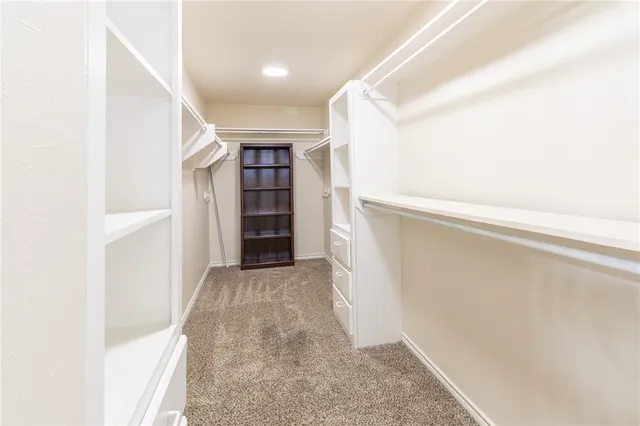 a view of hallway with stairs and a closet