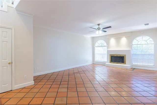 wooden floor chandelier and windows in a room