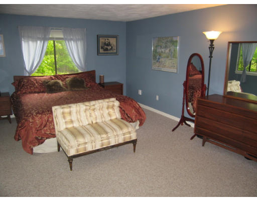 116 Mountain Gate Road, Unit 116 Ashland, MA 01721 - Photo 11 of 20 a bed sitting in a room next to a window