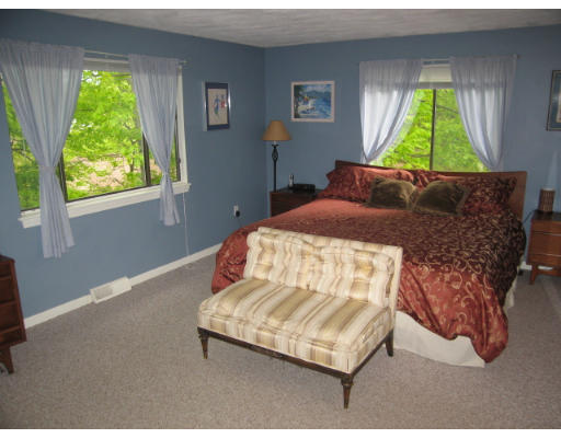 116 Mountain Gate Road, Unit 116 Ashland, MA 01721 - Photo 12 of 20 a bed sitting in a bedroom next to a window