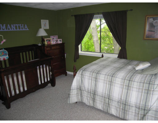 116 Mountain Gate Road, Unit 116 Ashland, MA 01721 - Photo 14 of 20 a bed sitting in a bedroom next to a window