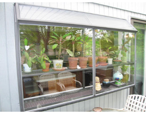 116 Mountain Gate Road, Unit 116 Ashland, MA 01721 - Photo 19 of 20 a living room with large trees and plants