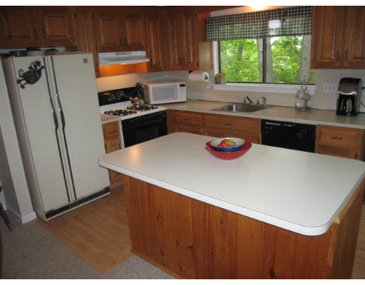116 Mountain Gate Road, Unit 116 Ashland, MA 01721 - Photo 6 of 20 a kitchen with stainless steel appliances a sink a refrigerator and a window