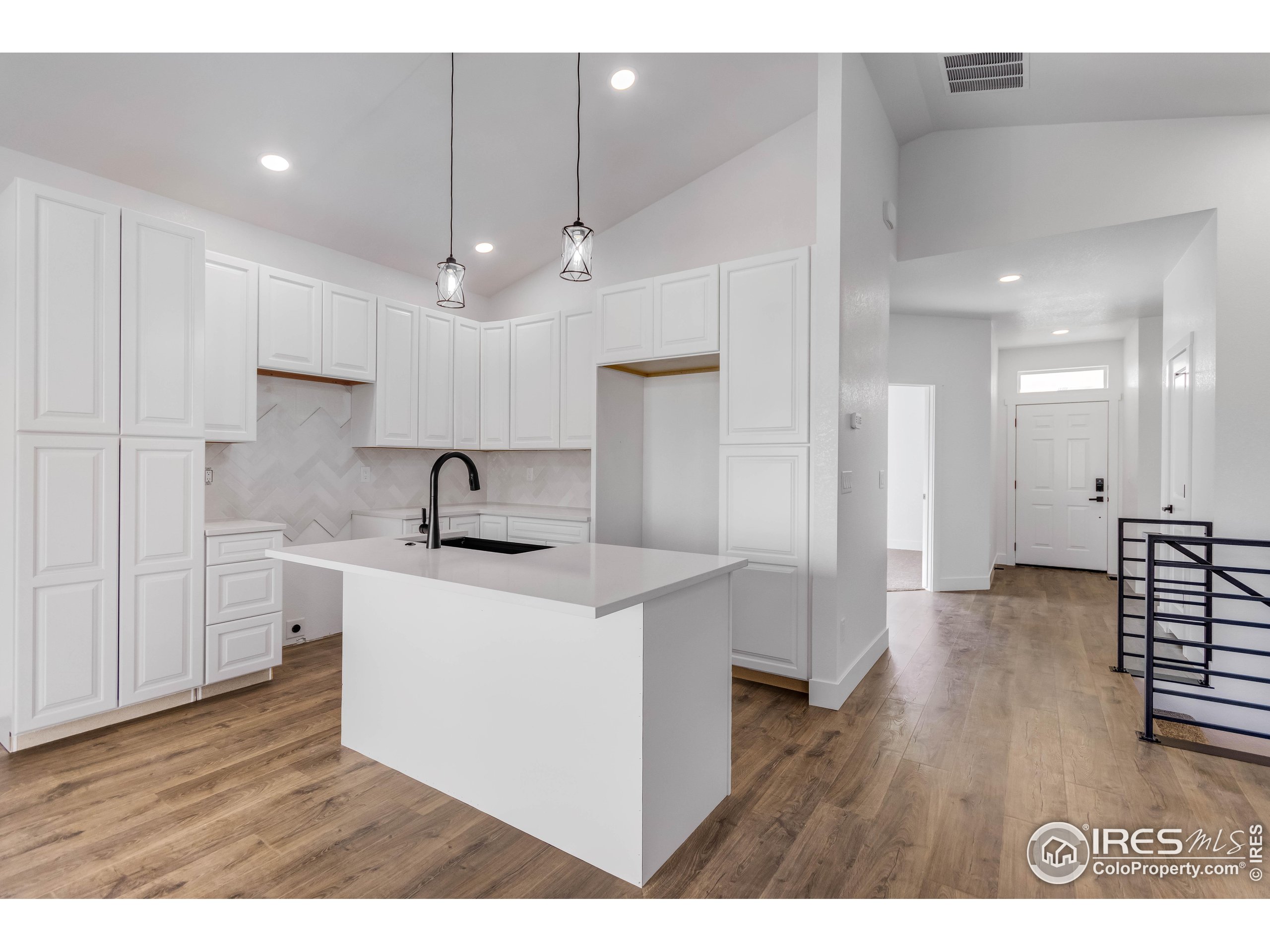 1230 Swainson Road Eaton, CO 80615 - Photo 12 of 35 a kitchen with kitchen island a sink stainless steel appliances and cabinets