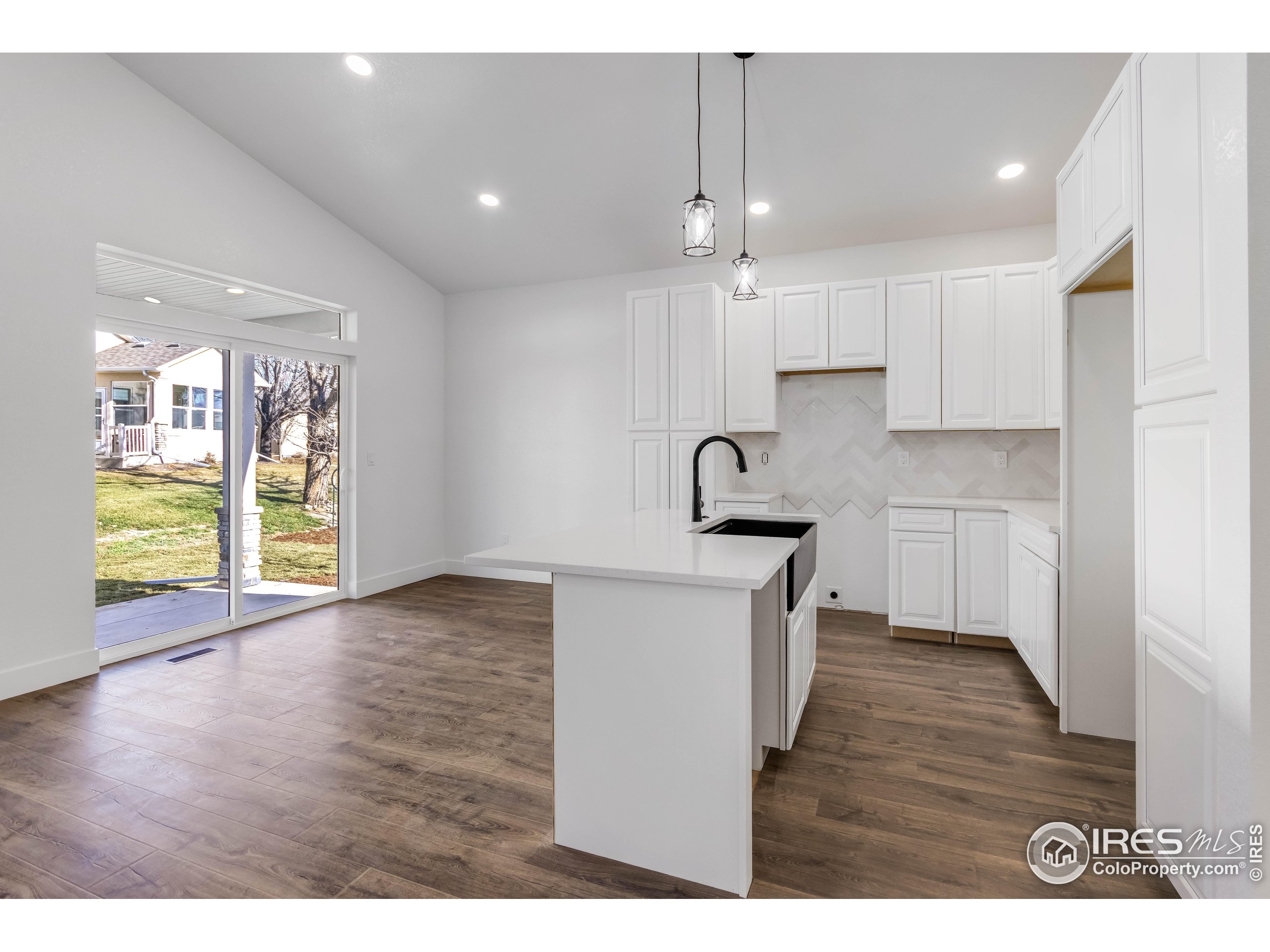 1230 Swainson Road Eaton, CO 80615 - Photo 13 of 35 a kitchen that has a lot of cabinets and wooden floor