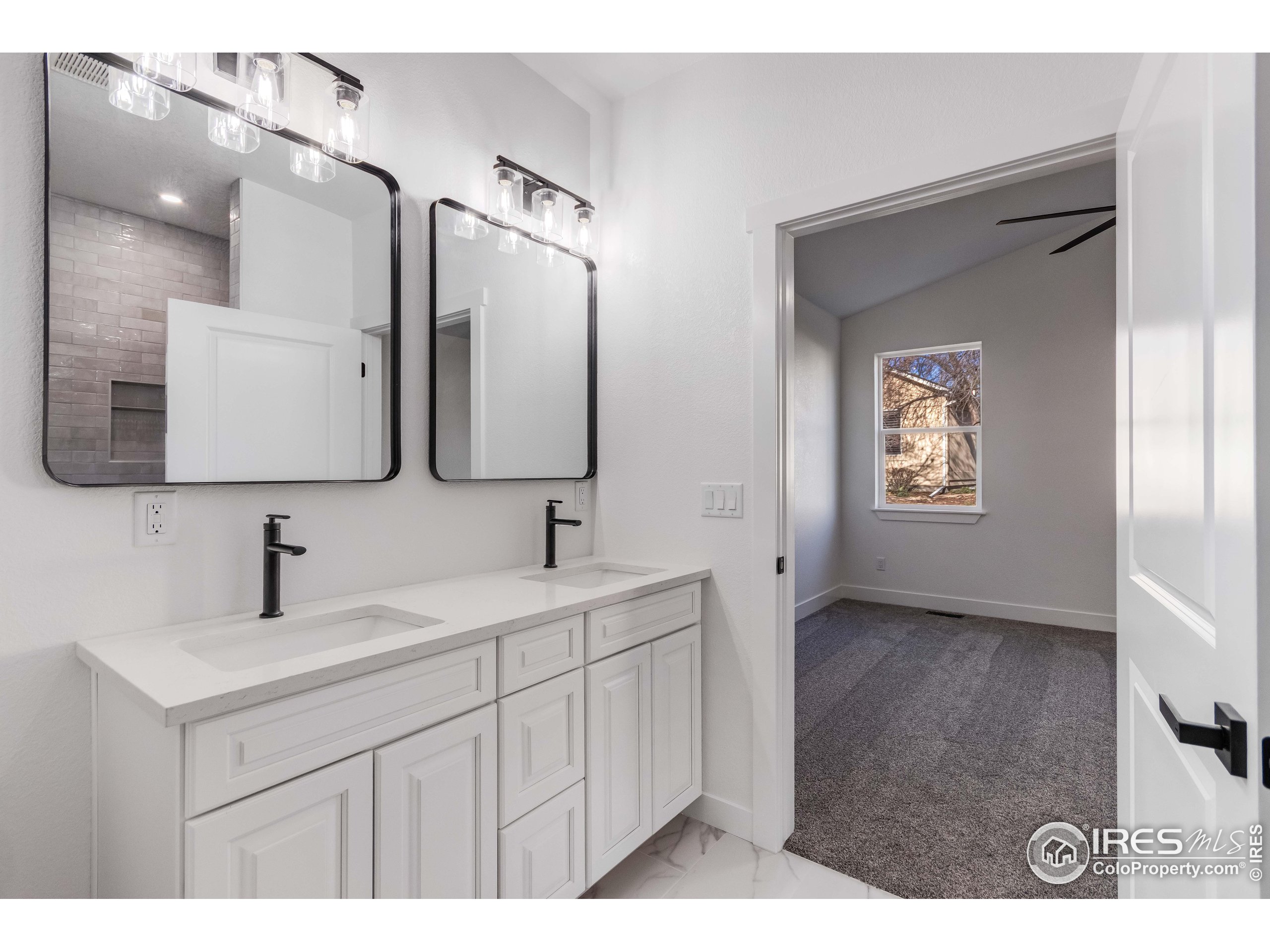 1230 Swainson Road Eaton, CO 80615 - Photo 24 of 35 a bathroom with a sink and a mirror