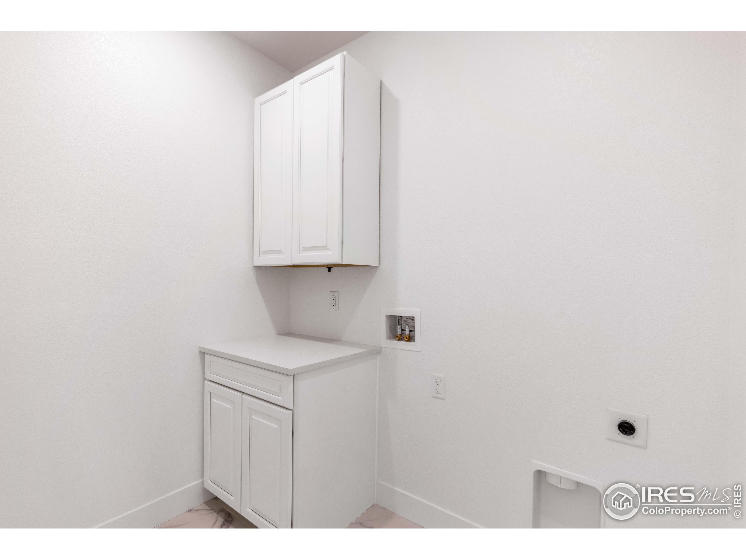 1230 Swainson Road Eaton, CO 80615 - Photo 4 of 35 a kitchen with white cabinets