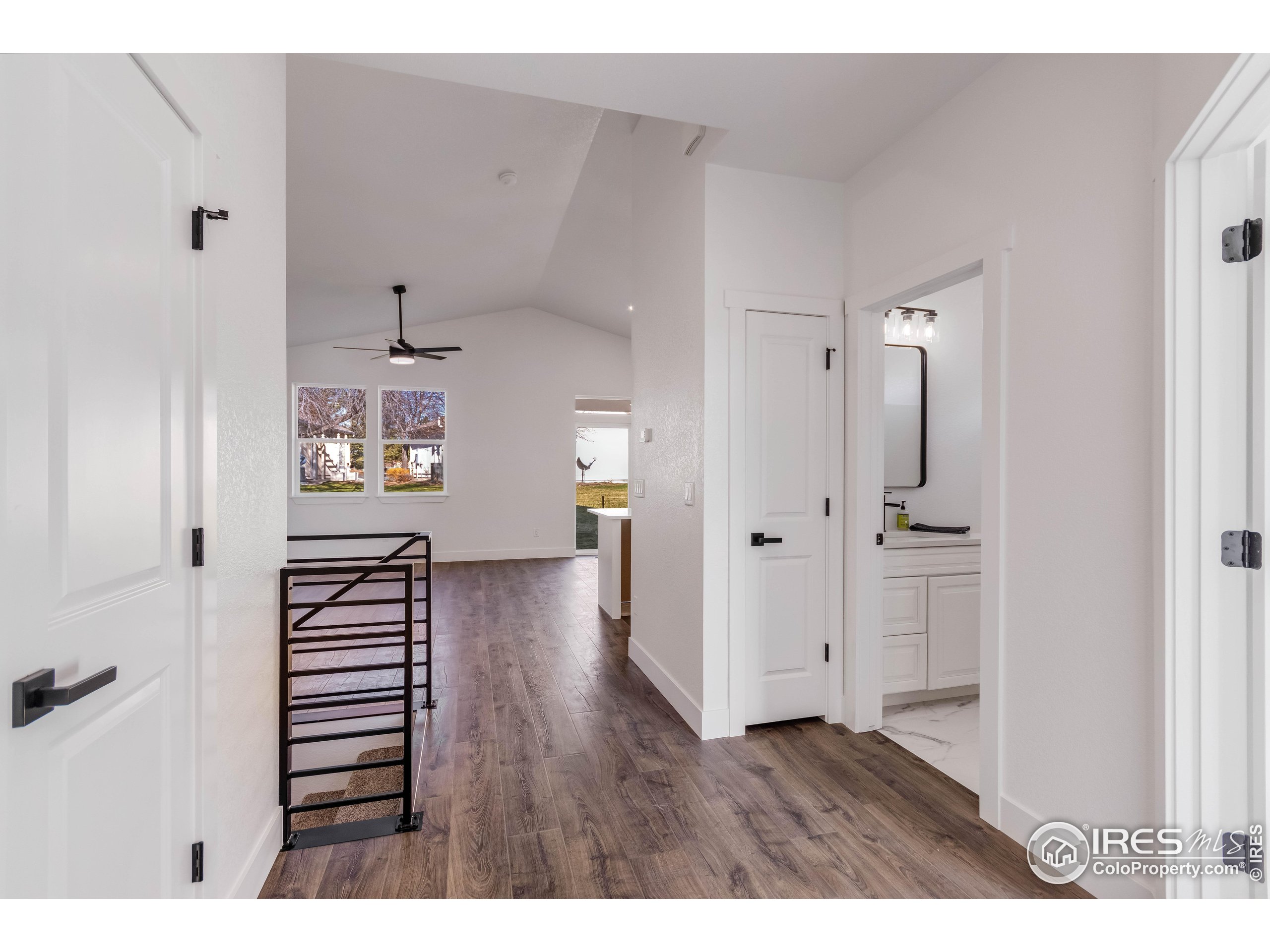 1230 Swainson Road Eaton, CO 80615 - Photo 5 of 35 a view of a hallway with wooden floor and furniture