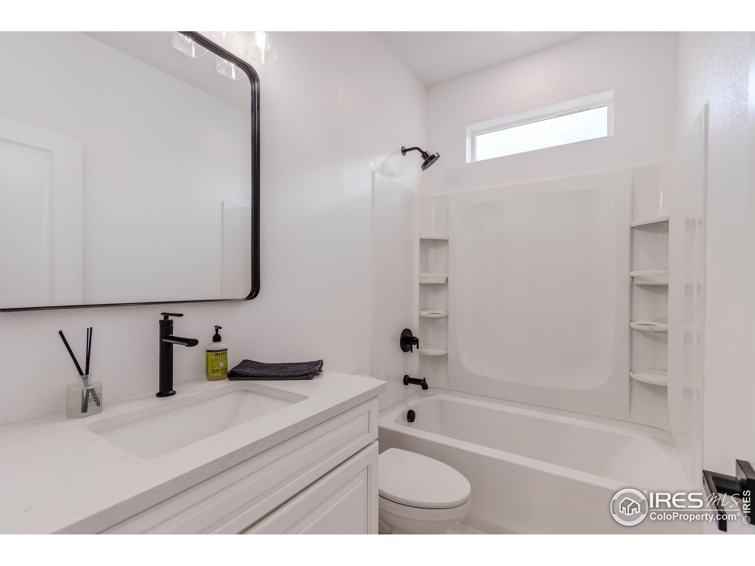 1230 Swainson Road Eaton, CO 80615 - Photo 7 of 35 a bathroom with a bathtub sink vanity and mirror