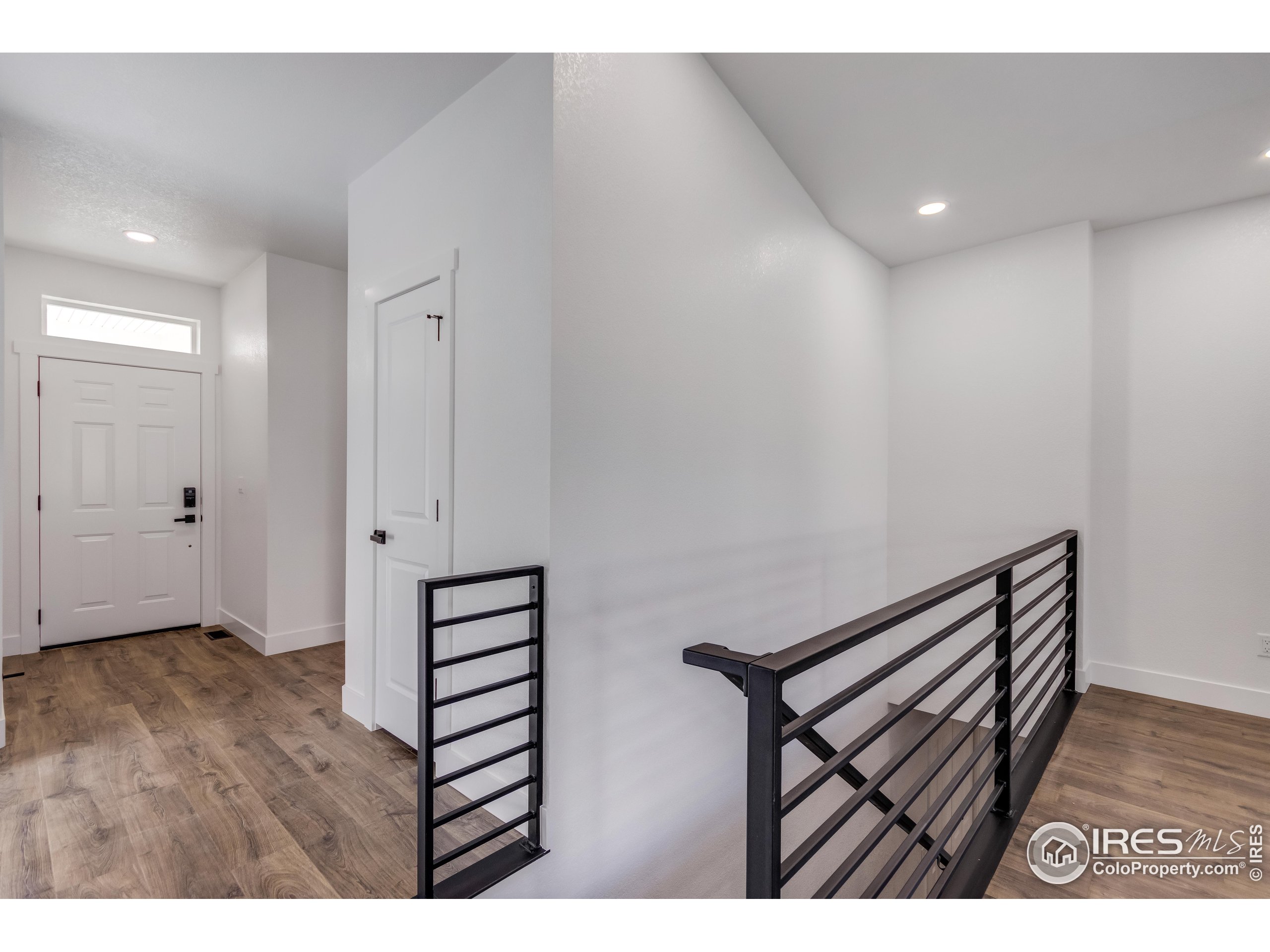 1230 Swainson Road Eaton, CO 80615 - Photo 8 of 35 a view of a hallway with wooden floor